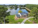 Aerial view of house on lake with large yard and circular driveway at 120 Edgewater Dr, Broadway, NC 27505