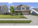 Two-story house with a neutral color scheme and a landscaped lawn at 151 National Dr, Clayton, NC 27527