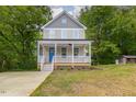 Two-story craftsman style home with gray siding, white trim, and a front porch at 705 Jefferson St, Henderson, NC 27536