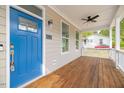 Inviting front porch with blue door and wood decking at 705 Jefferson St, Henderson, NC 27536