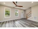 Living room with hardwood floors and a view of the staircase at 705 Jefferson St, Henderson, NC 27536