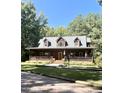 Two story home with wraparound porch and landscaping at 1150 Old County Home Rd, Nashville, NC 27856
