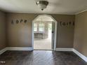 View of dining area with tile floor and archways to other rooms at 511 Usher St, Durham, NC 27704