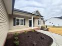 Inviting front porch with landscaping at 41 Preacher Ln, Angier, NC 27501