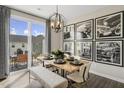 Modern dining area with wood table, patio access, and stylish wall art at 215 Anise Ln, Garner, NC 27529