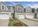 Townhome building showcasing attached garages and a manicured lawn at 219 Anise Ln, Garner, NC 27529