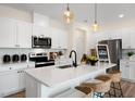 Modern kitchen with white cabinets, stainless steel appliances, and an island at 219 Anise Ln, Garner, NC 27529