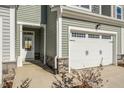 Front entry and attached garage with stone accents at 219 Anise Ln, Garner, NC 27529