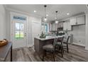 Modern kitchen featuring an island with seating, stainless steel appliances, and sleek cabinetry at 145 Leisure Ln, Louisburg, NC 27549