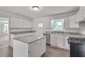Updated kitchen with white cabinets, granite countertops, and island at 2171 Bud Lipscomb Rd, Willow Springs, NC 27592
