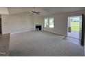 Spacious living room with a fireplace and access to porch at 139 Grace Ridge Ct, Benson, NC 27504