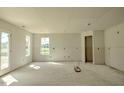 Spacious unfinished room with drywall and large window at 55 Marley Dr, Dunn, NC 28334