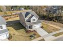 Two-story house with a two car garage, front yard, and a street view at 36 Railcar Way, Clayton, NC 27520