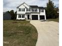 Two-story home with black accents and a long driveway at 54 Bonsai Way, Four Oaks, NC 27524