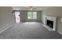 Living room features a fireplace and large windows at 54 Bonsai Way, Four Oaks, NC 27524