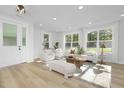 Bright and airy living room with large windows and light-colored furniture at 3024 White Rail Dr, Fuquay Varina, NC 27526