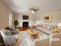 Virtually staged living room with fireplace and hardwood floors at 27 Pine Croft Rd, Angier, NC 27501