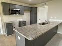 Modern kitchen with gray cabinets and granite countertops at 53 Grace Ridge Ct, Benson, NC 27504