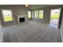 Bright living room with fireplace and access to backyard at 95 Grace Ridge Ct, Benson, NC 27504