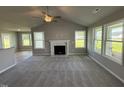 Spacious living room featuring a fireplace and large windows at 95 Grace Ridge Ct, Benson, NC 27504