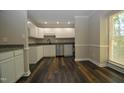 Kitchen with white cabinets, granite countertops, and stainless steel appliances at 500 W Woodcroft Pkwy Pkwy # 8C, Durham, NC 27713