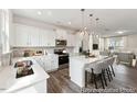 Modern kitchen with white cabinets and island at 156 Camel Crazies Pl # 35, Lillington, NC 27546