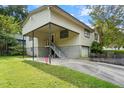 Single story home with elevated carport and stairs at 318 W Virginia St, Rocky Mount, NC 27804