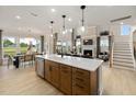 Open concept kitchen with large island, stainless steel appliances, and hardwood floors at 116 E Star Foal Ln, Wendell, NC 27591
