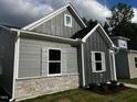 Modern gray house with stone accents and landscaping at 804 Dorset Stream Dr, Fuquay Varina, NC 27526