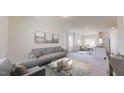 Spacious living room with a gray sofa and ample natural light at 334 Glover Pk Mem Dr, Nashville, NC 27856