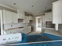 White kitchen with herringbone backsplash and ample counter space at 81 Seahawk Way, Zebulon, NC 27597