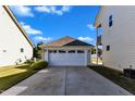 Attached garage with double doors and a concrete driveway at 46 Heathwood Dr, Clayton, NC 27527