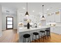 Spacious kitchen with white cabinets, island, and hardwood floors at 7800 Ailesbury Rd, Wake Forest, NC 27587