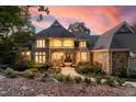 Elegant two-story home with stone facade, a grand entrance, and landscaping at 32430 Archdale, Chapel Hill, NC 27517