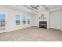 Bright living room features a fireplace and views of the backyard at 274 Steep Rock Dr, Willow Springs, NC 27592