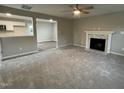 Living room with fireplace and view into kitchen at 223 Bonsai Way, Four Oaks, NC 27524