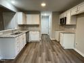Kitchen with white cabinets and granite countertops at 223 Bonsai Way, Four Oaks, NC 27524