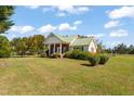 Brick ranch house with a front porch and green metal roof at 3012 Orange Grove Rd, Hillsborough, NC 27278