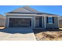New construction home with open garage, gray siding and teal accents at 77 Frasier Fir Way, Lillington, NC 27546