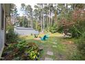 Spacious backyard with firepit and mature trees at 305 S Walnut St, Spring Hope, NC 27882