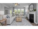 Living room featuring a neutral color palette, fireplace, and ample natural light at 5013 Trotter Dr, Raleigh, NC 27603