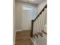 Bright entryway with wood-look floors and staircase at 2038 Fishamble St, Fuquay Varina, NC 27526