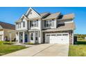 Two-story house with gray siding, white trim, and a stone facade at 109 Campaign Dr, Mebane, NC 27302