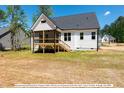 Home's back features a deck and screened porch at 775 Vick Rd, Spring Hope, NC 27882