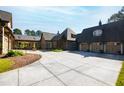 Luxury home with stone and shingle exterior, multiple garages and expansive driveway at 3700 Lark Farm Rd, Franklinton, NC 27525