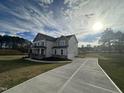 Two-story house with driveway and landscaping, showcasing curb appeal at 23 Quail Point Cr, Clayton, NC 27520