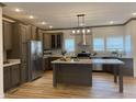 Spacious kitchen featuring an island, stainless steel appliances, and light wood flooring at 6733 Oscar Barham Rd, Wake Forest, NC 27587