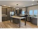Spacious kitchen featuring an island, stainless steel appliances, and light wood flooring at 6733 Oscar Barham Rd, Wake Forest, NC 27587