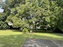 Spacious backyard with mature trees and grassy area at 414 E Morehead St, Burlington, NC 27215