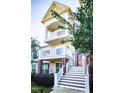 Three-story house with brick and siding, featuring a front porch and stairs at 10420 Sablewood Dr # 115, Raleigh, NC 27617